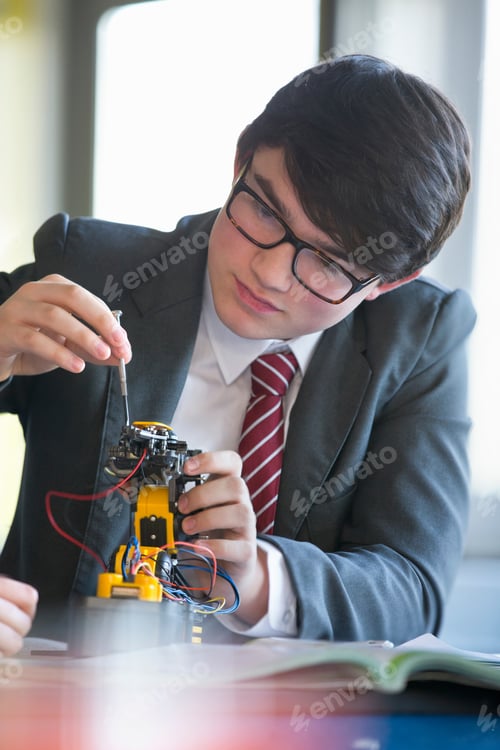 Preview: Focused High School Student Assembling Robot In Science Class