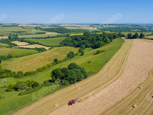 Preview: Aerial View Of Tractor Baling Hay In Field