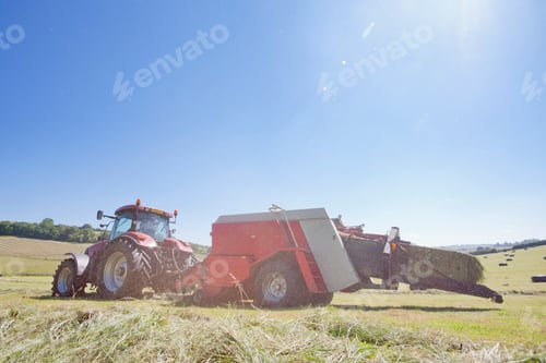 Preview: Wide Shot Of A Tractor Baling Hay In The Field