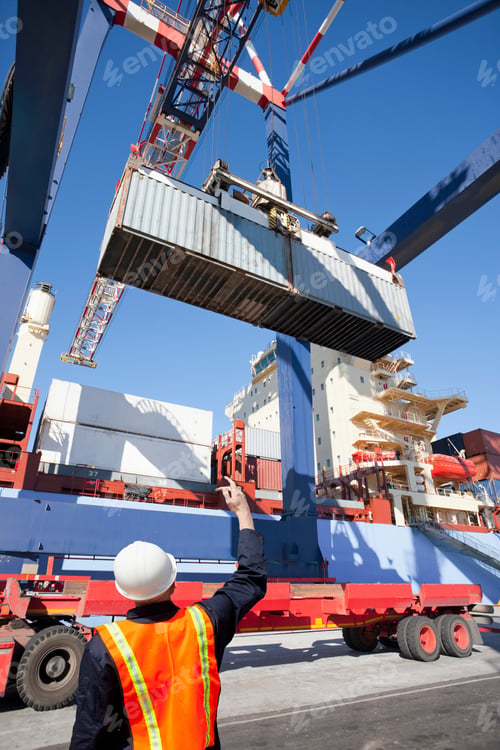 Preview: Vertical Shot Of A Worker Directing The Crane Controller To Place The Cargo On A Lorry