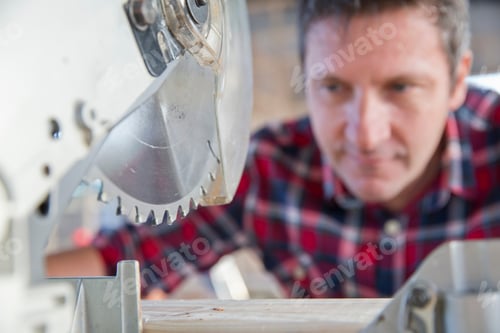 Preview: Close Up Of The Circular Blade Of The Cutting Saw And The Carpenter In The Background