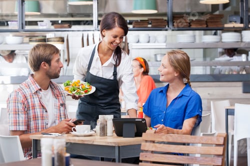 Preview: Cheerful Waitress Serving A Couple Salad In Dishes