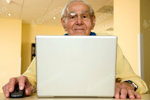 Preview: An Elderly Man Using A Laptop