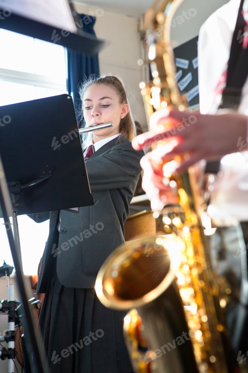 Preview: Vertical Shot Of A High School Students Playing A Saxophone Flute In A Music Class.