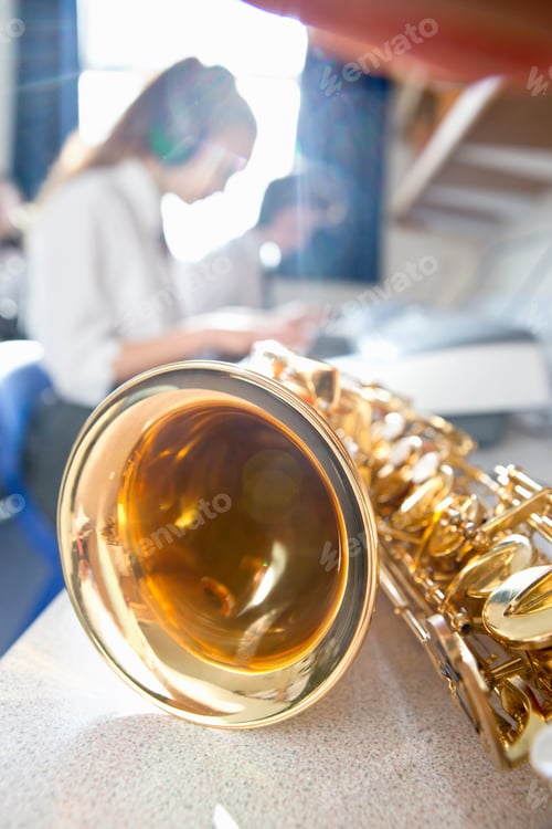 Preview: Vertical Shot Of A Shiny Brass Saxophone On Table In A High School Music Class