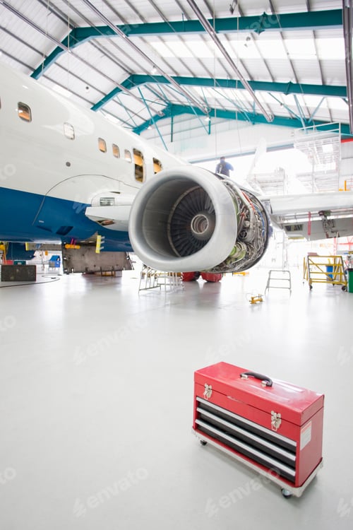 Preview: Vertical Wide Shot A Passenger Jet At A Hangar With A Toolbox In The Foreground.