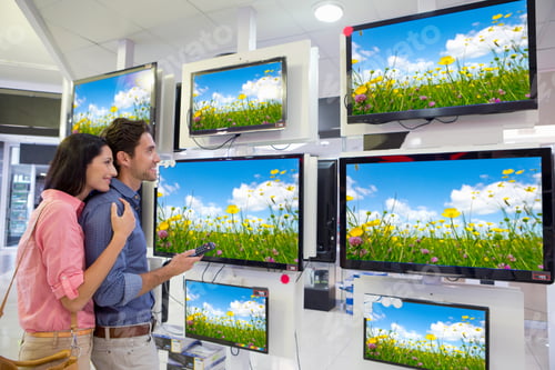 Preview: Medium Shot Of A Couple Looking At A Surfer On Multiple Flat Screen Televisions At An Electronics