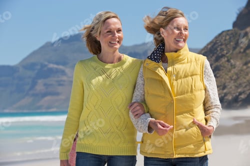 Preview: Medium Shot Of A Mother And Daughter Walking Along The Shore Of A Sunny Beach.
