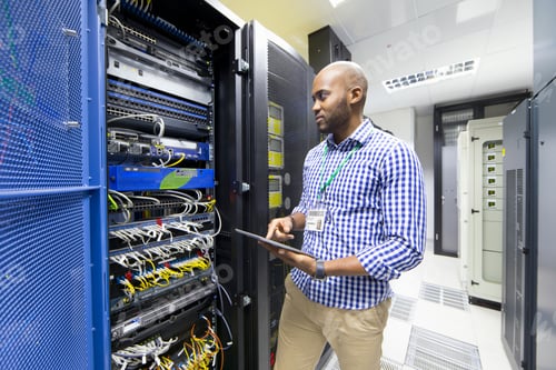 Preview: Technician With A Digital Tablet Checking The Server In Data Center