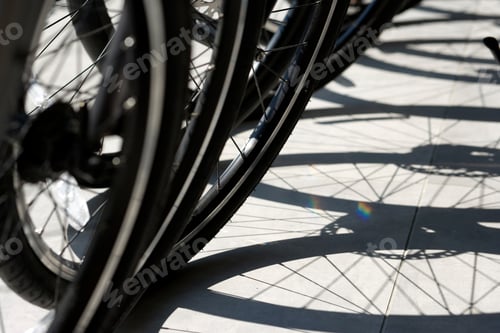Preview: Close Up Shot Of Bicycle Tyres And Their Shadows On The Ground.