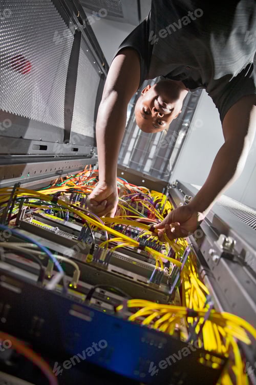 Preview: Vertical Shot Of A Technician Checking The Wires In The Data Center