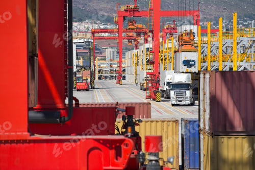 Preview: Multiple Cranes Loading Cargo Containers Onto Trucks At A Commercial Dock.