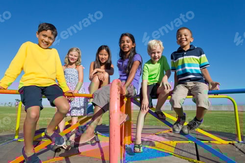 Preview: A Group Of Children Sitting On A Carousel In A Park