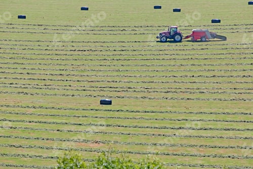 Preview: Tractor Baling Hay In Field