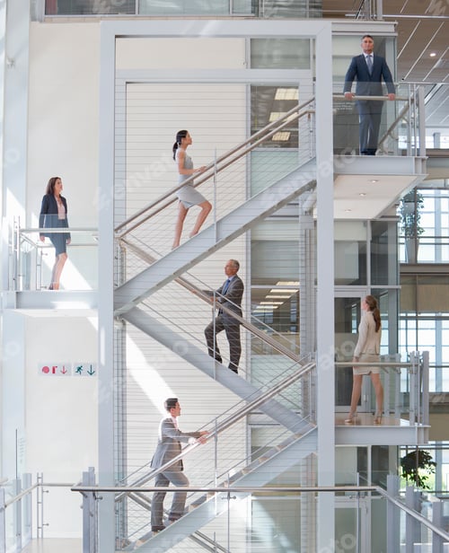 Preview: Business Employees Ascending Stairs In An Office