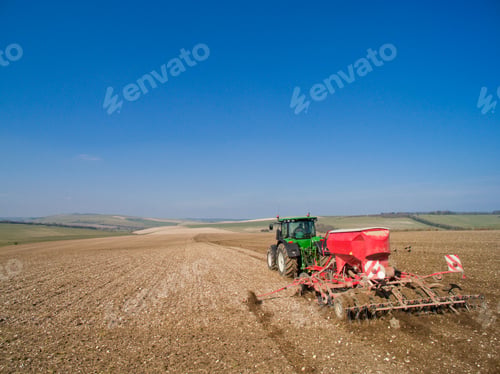 Preview: Rear View Of Tractor Pulling Seed Drill In Field