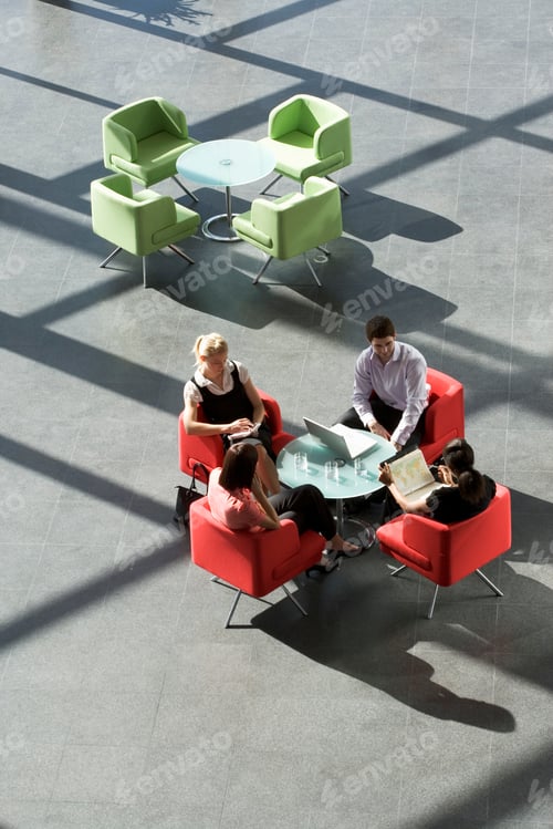 Preview: Four Business Colleagues Holding A Business Meeting