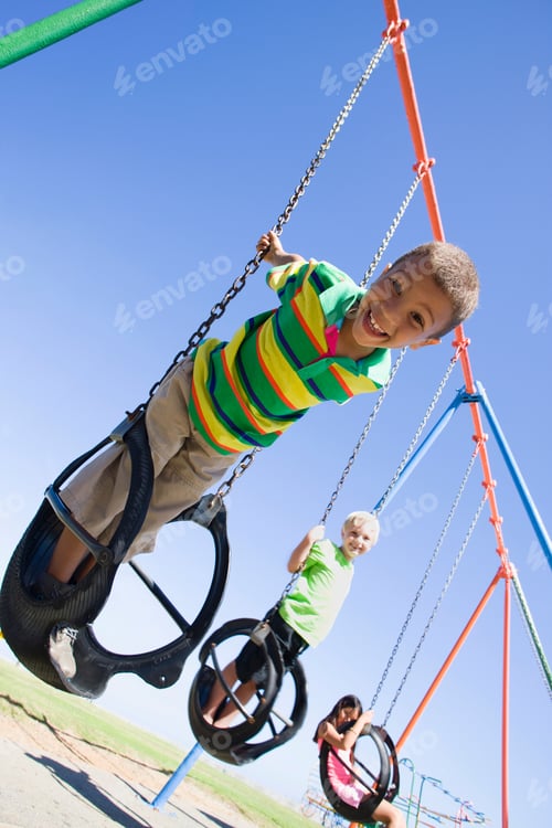 Preview: Children Playing On A Swing Set At A Playground