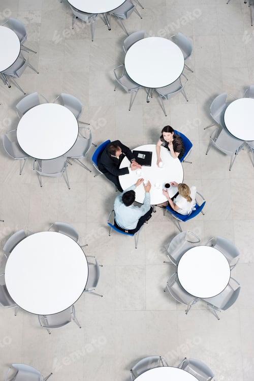 Preview: Overhead View Of Informal Business Meeting At Table Of Staff Canteen