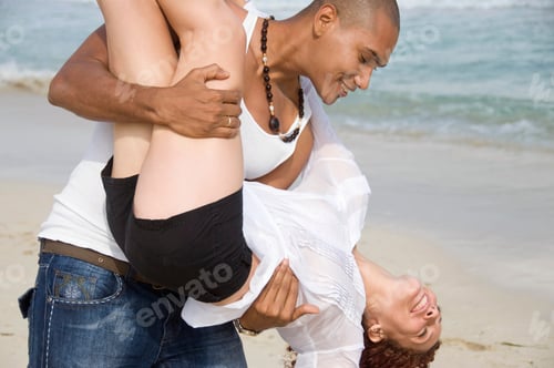 Preview: Man Carrying Young Woman On Beach, Smiling, Havana, Cuba