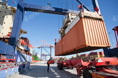 Preview: Wide Shot Of A Worker Directing The Crane Controller To Place The Cargo On A Lorry