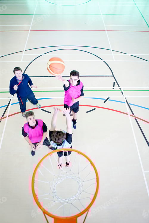 Preview: High-Angle Vertical Shot Of High School Students Playing Basketball During A Gym Class.