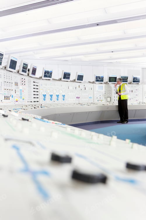 Preview: Vertical Shot Of A Senior Engineer In A Reflector Vest Using A Walkie-Talkie In The Control Room Of