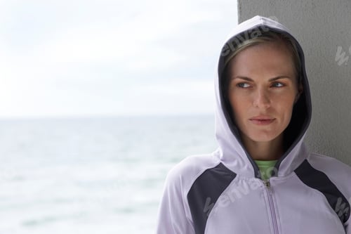 Preview: Medium Shot Of A Woman In A Hoodie With The Sea In The Background.