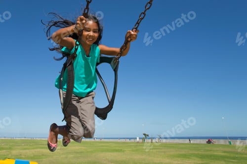 Preview: Wide Shot Of A Smiling Girl Swinging On Swing