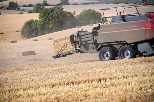 Preview: Tractor Baler Making Straw Bales In Field After Summer Wheat Harvest On Farm