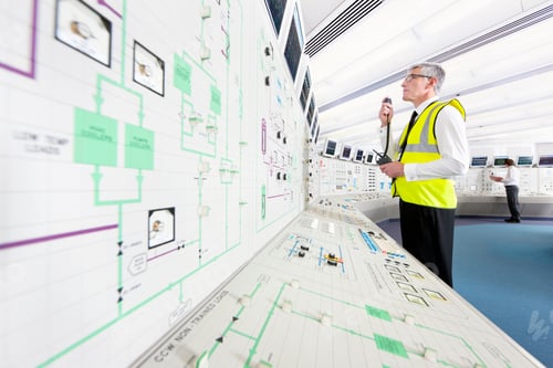 Preview: Senior Engineer In A Reflector Vest Using A Walkie-Talkie In The Control Room Of A Nuclear Power