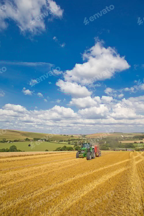 Preview: Vertical Wide Shot Of Multiple Tractors Bailing Straw In A Rural Field.