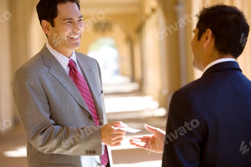 Preview: Two Smiling Businessmen Meeting Exchange Business Cards Outdoors