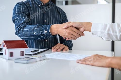 Preview: Real Estate Agent And Customers Shaking Hands Together Celebrating Finished Contract After Signing