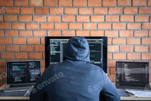 Preview: Computer Hacker Or Cyber Attack Concept, Dangerous Hooded Hacker Using Multiple Computers Typing