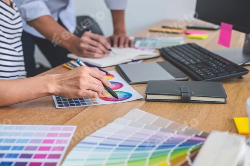 Preview: Two Colleagues Creative Graphic Designer Working On Color Selection And Drawing On Graphics Tablet