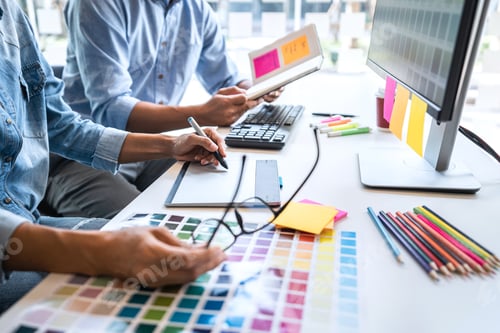 Preview: Young Colleagues Designers Working Together On A Creative Project And Color Samples For Selection