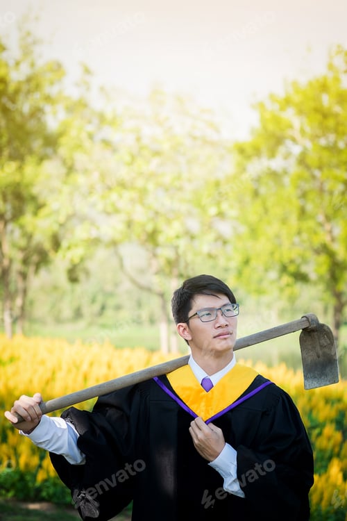 Preview: Graduation: Student Standing Carrying A Shovel With Diploma With