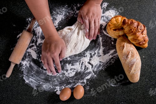 Preview: Raw Dough For Bread With Ingredients On Black Background, Male Hands Kneading Dough Sprinkled With