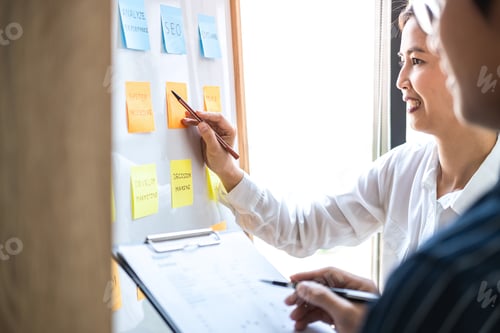 Preview: Two Creative Business People Meeting And Planning Use Post It Notes Sticky Note On Board To Share