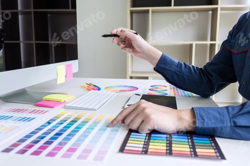 Preview: Male Creative Graphic Designer Working On Color Selection And Color Swatches, Drawing On Graphics