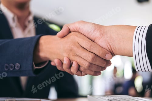 Preview: Two Smiling Businessman Shaking Hands Together After Good Deal Connection To Join Investment