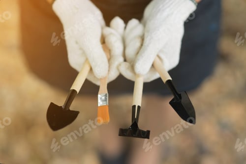 Preview: Close Up Hands Of Young Woman Holding Gardening Tools