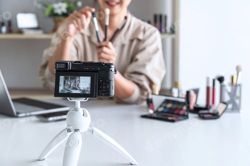 Preview: Happy Smiling Elegant Woman Or Beauty Blogger With Brush On Recording Video While Review Product