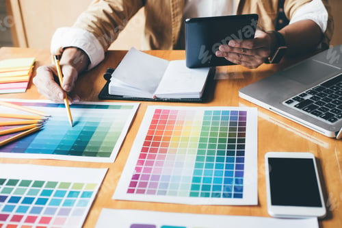 Preview: Young Creative Graphic Designer Using Graphics Tablet To Choosing Color Swatch Samples Chart For