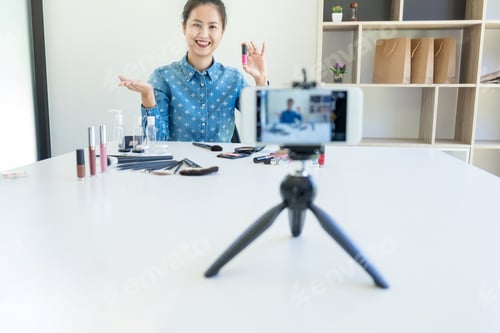 Preview: Happy Smiling Elegant Woman Or Beauty Blogger With Brush On Recording Video While Review Product