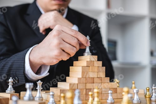 Preview: Wooden Game Of Strategy, Hands Of Confident Businessman Playing Chess Game To Development Analysis