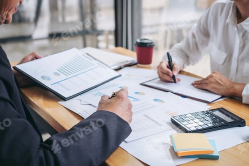 Preview: Teamwork: Business Professionals Collaborating on Financial Analysis