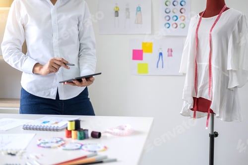 Preview: Stylish Fashion Designer Working With Measure Red Dummy As Sketches In Digital Tablet Of New