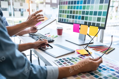 Preview: Young Colleagues Designers Working Together On A Creative Project And Color Samples For Selection